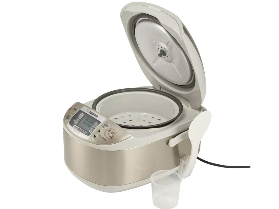 opened rice cooker with scoop and paddle