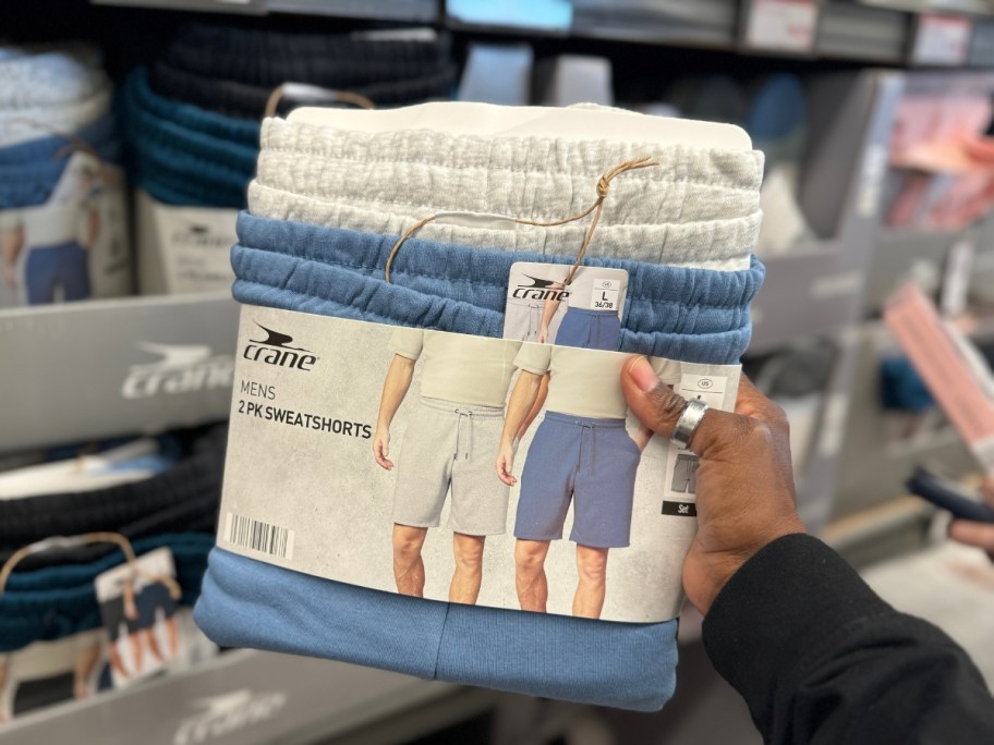 hand holding a 2-pack of men's shorts