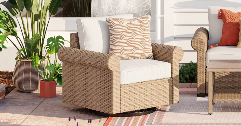 wicker patio chair with white cushions