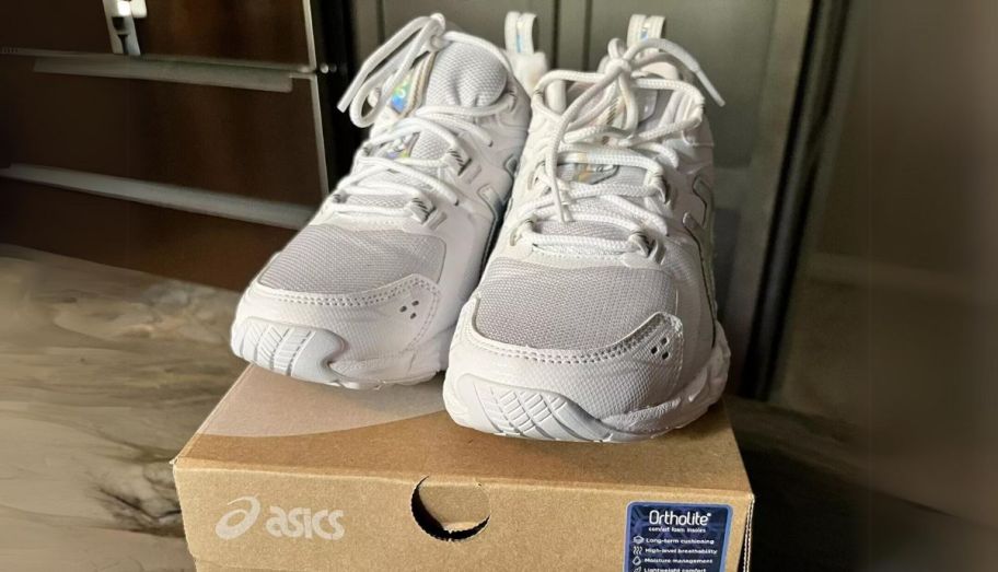 a pair of white womens asics gel quantum 180 shoes on top of an asics shoes box