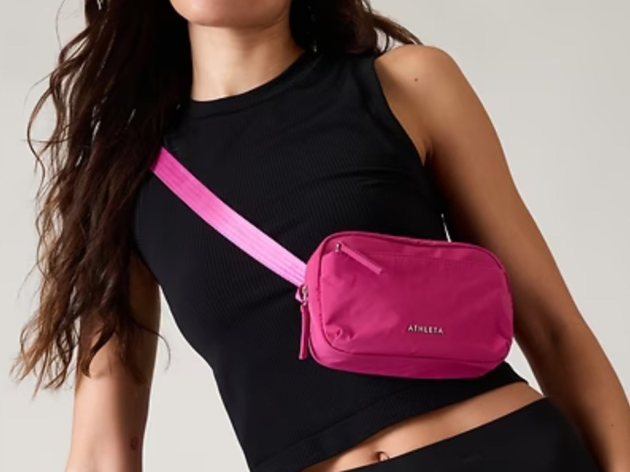 woman wearing a hot pink Athleta belt bag