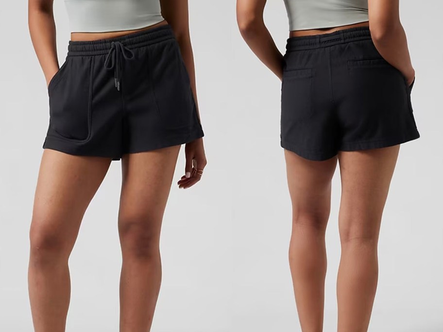 woman front and back image wearing black shorts and gray top