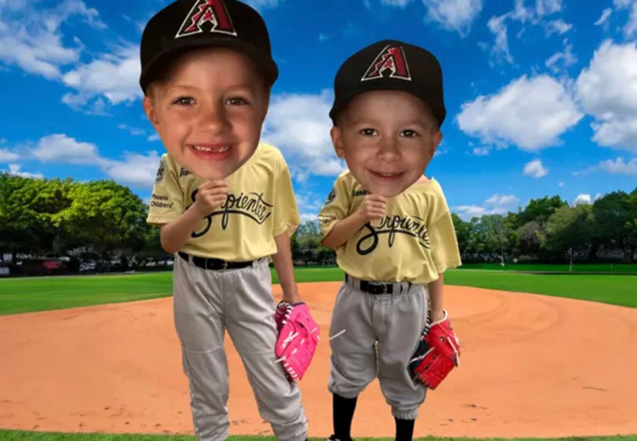 two kids holding big cutouts in baseball field 