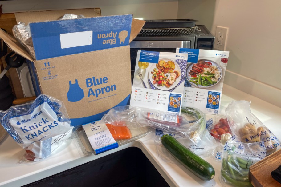blue apron box with ingredients spread out