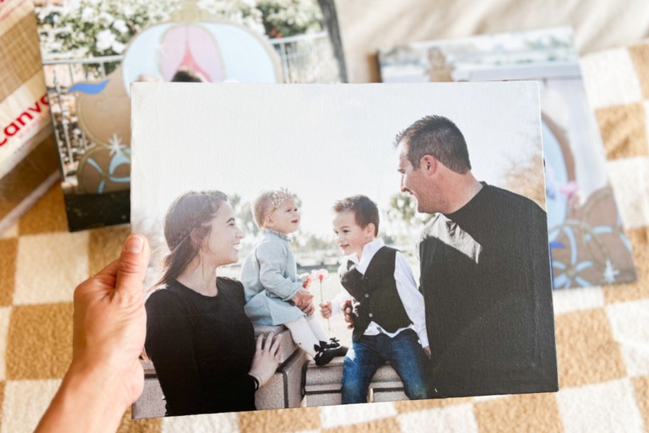 canvas of family of four with other canvases