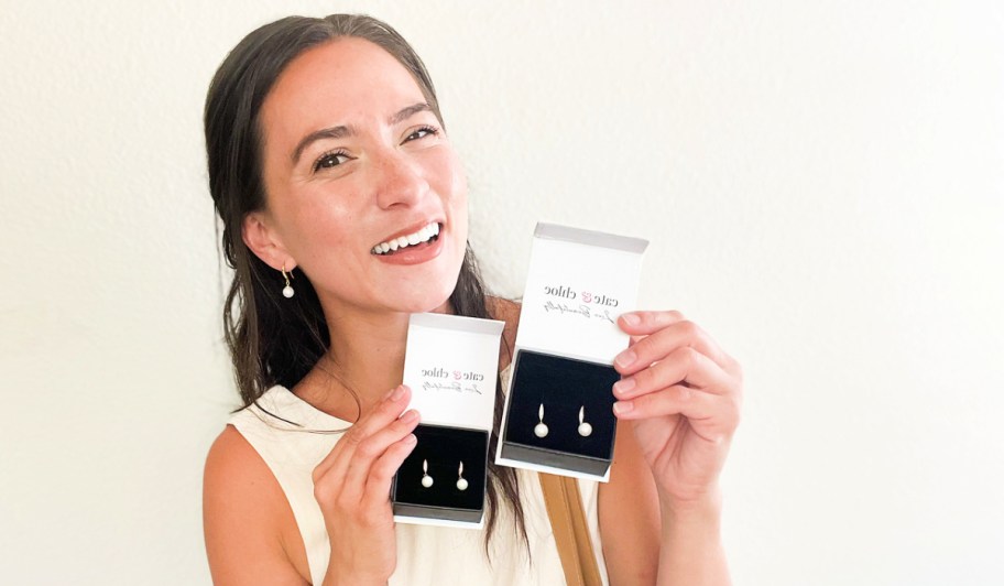 woman wearing and holding up pairs of cate & chloe betty earrings