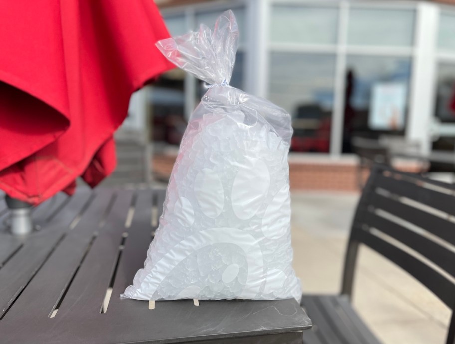 chick fil a bag of ice sitting on patio table outside of fast food restaurant
