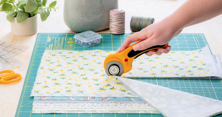 person using a cutter on fabric