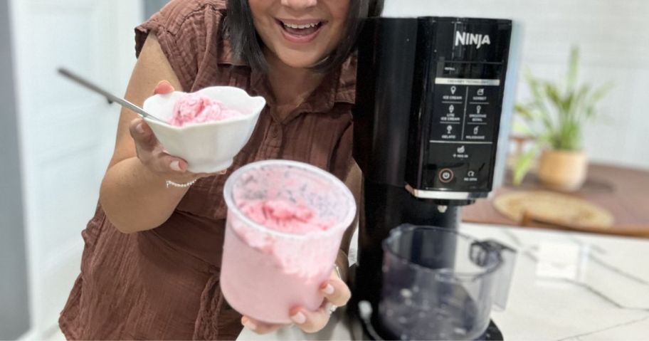 Ninja CREAMi 7-in-1 Frozen Treat Maker with Extra Pint Containers with woman holding ice cream container and bowl with pink ice cream in them