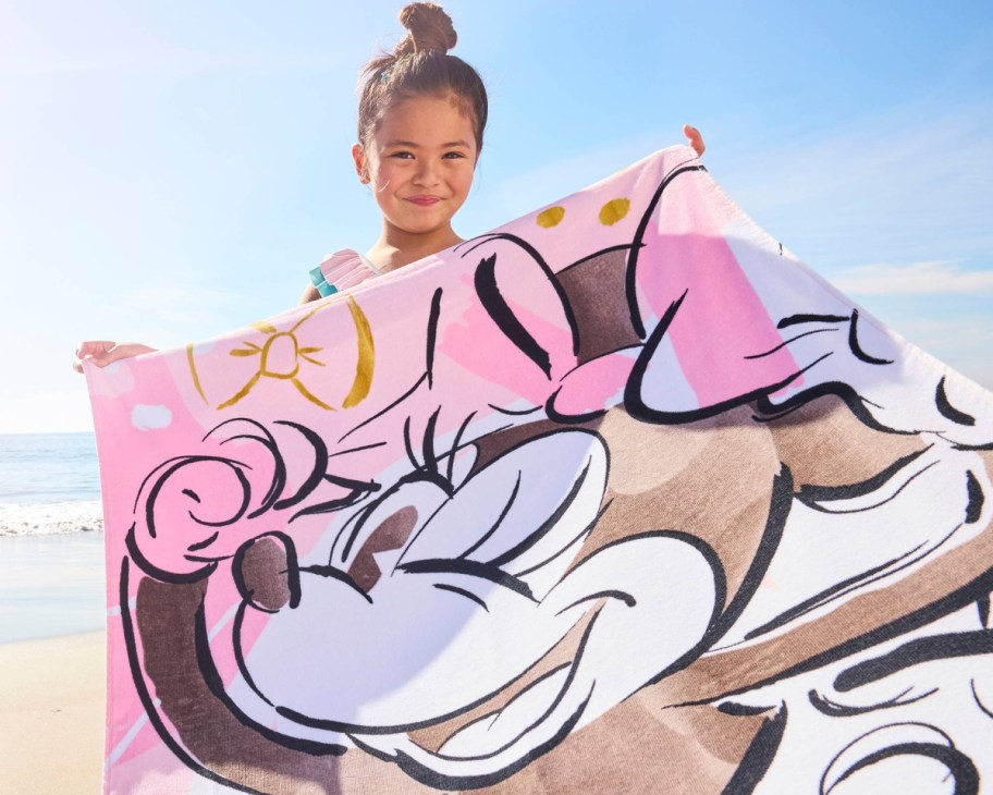 girl holding minnie mouse towel 