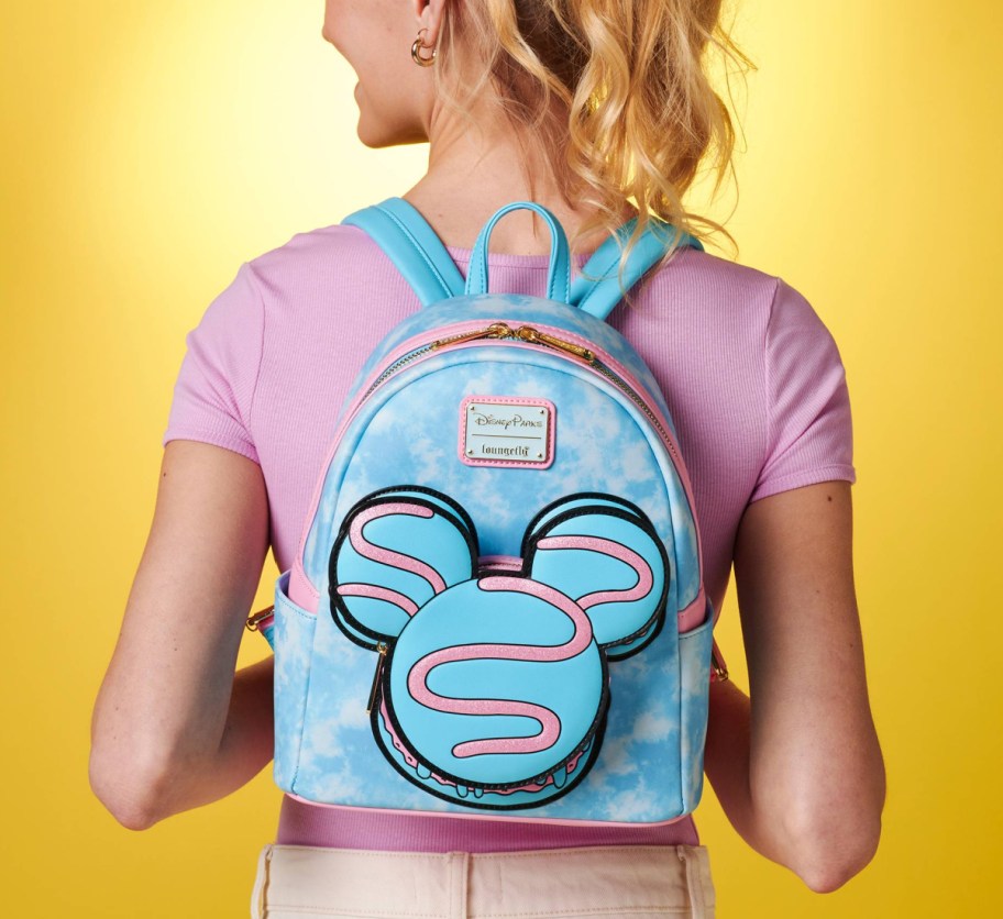 light blue mickey macaron backpack on womans back