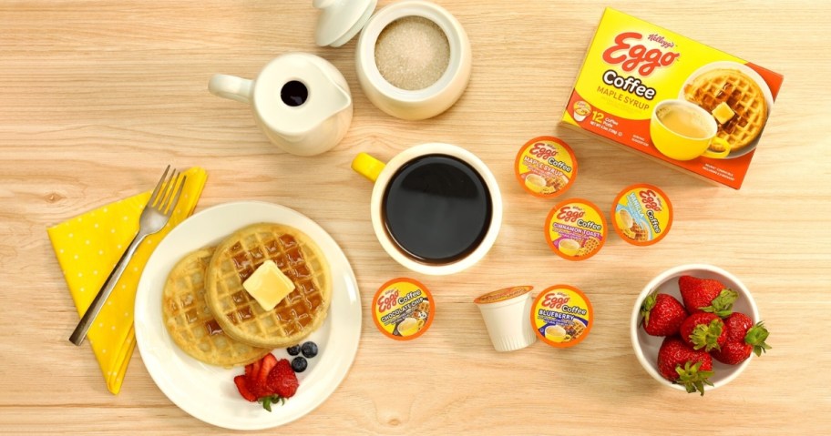 Eggo waffles on a plate next a cup of coffee and Eggo Coffee k-cup pods and box of pods