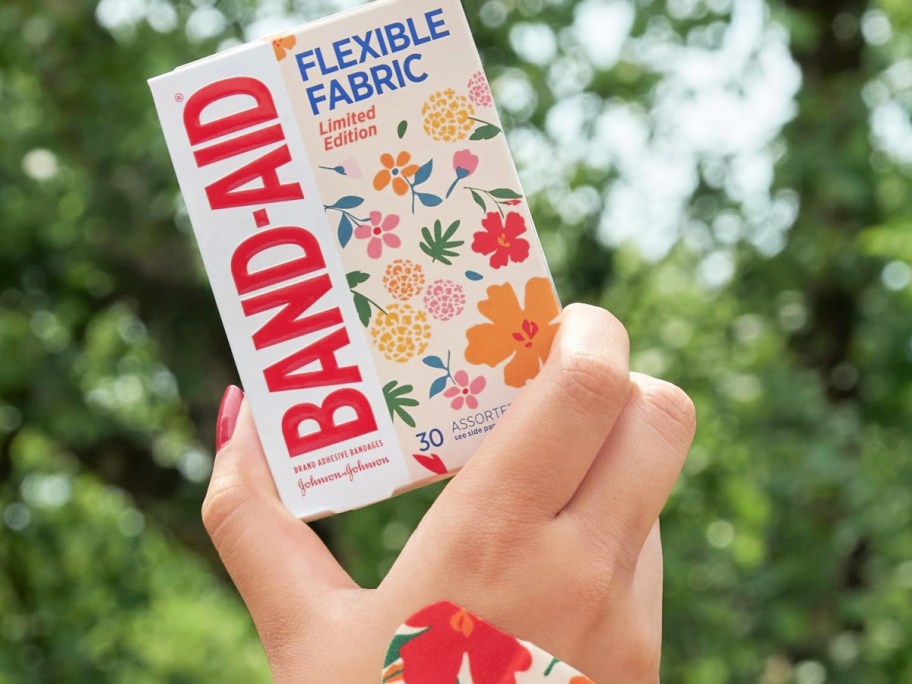 floral band-aids box in hand