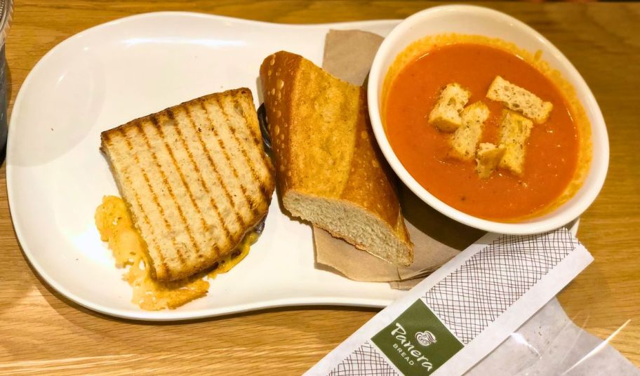 a bowl of tomato soup and half a grilled cheese sandwich at panera