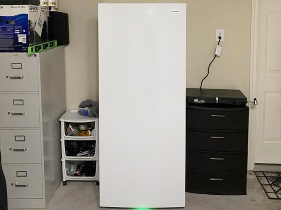 frigidaire white refrigerator in garage 
