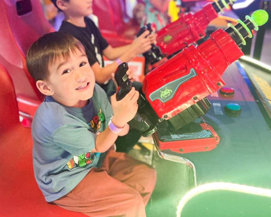 little boy playing in arcade