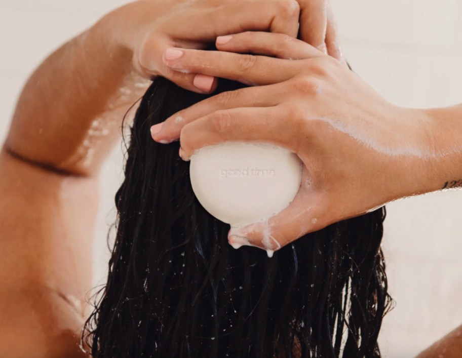 hands washing hair with shampoo bar