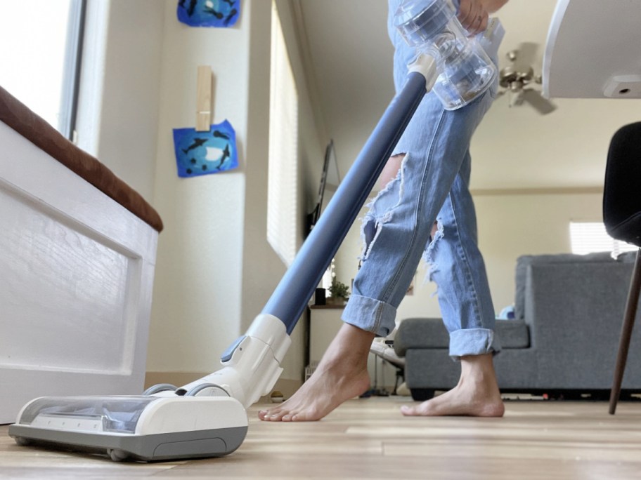 woman in overalls vacuuming