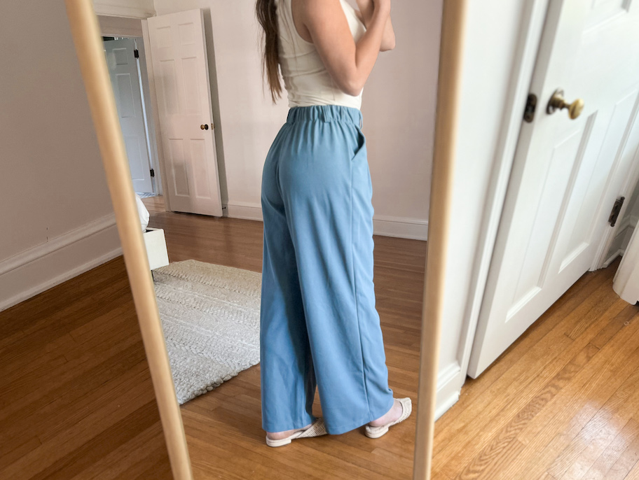 woman showing the back of blue pants
