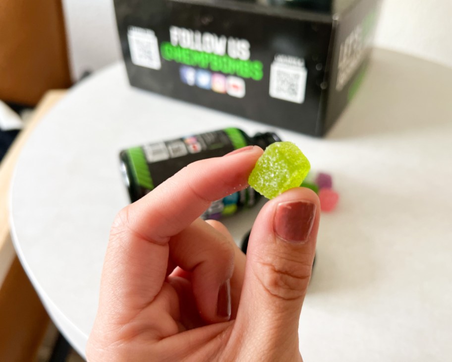 hand holding green sleep gummy