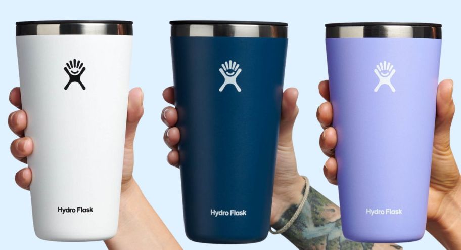 3 models hands holding 28oz hydro flask tumblers