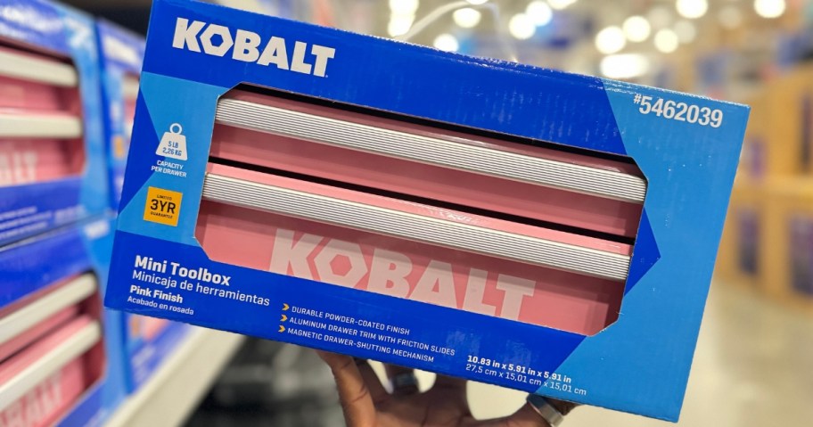 hand holding a blue box with a pink Kobalt mini toolbox in it in a Lowes store aisle