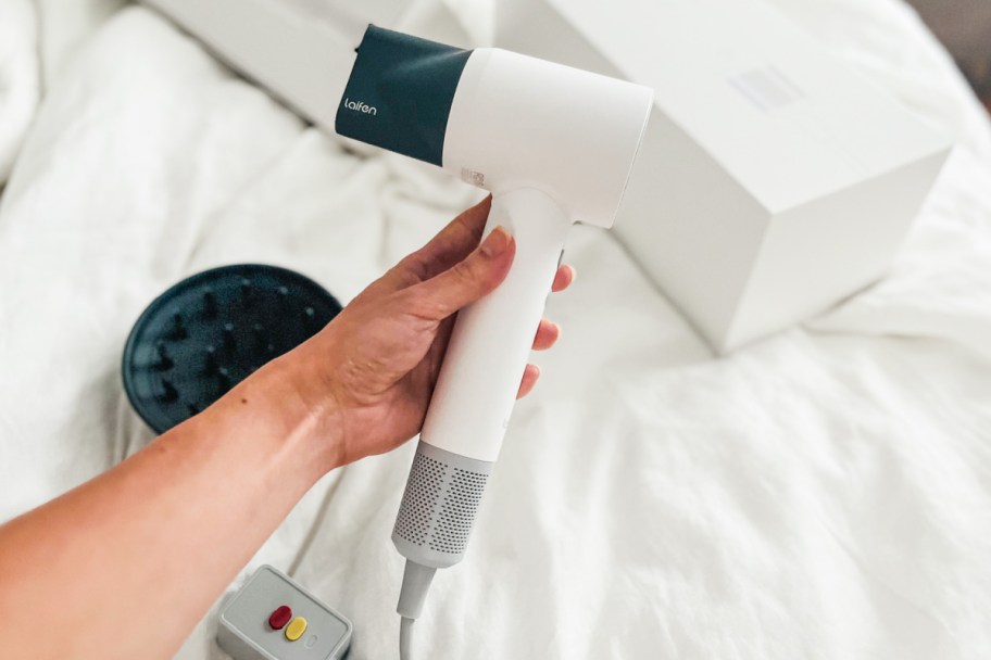 hand holding white hair dryer