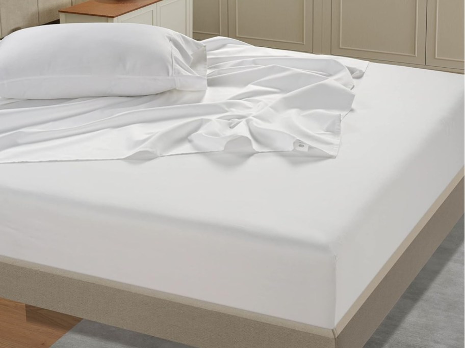wrinkled white sheet on bed