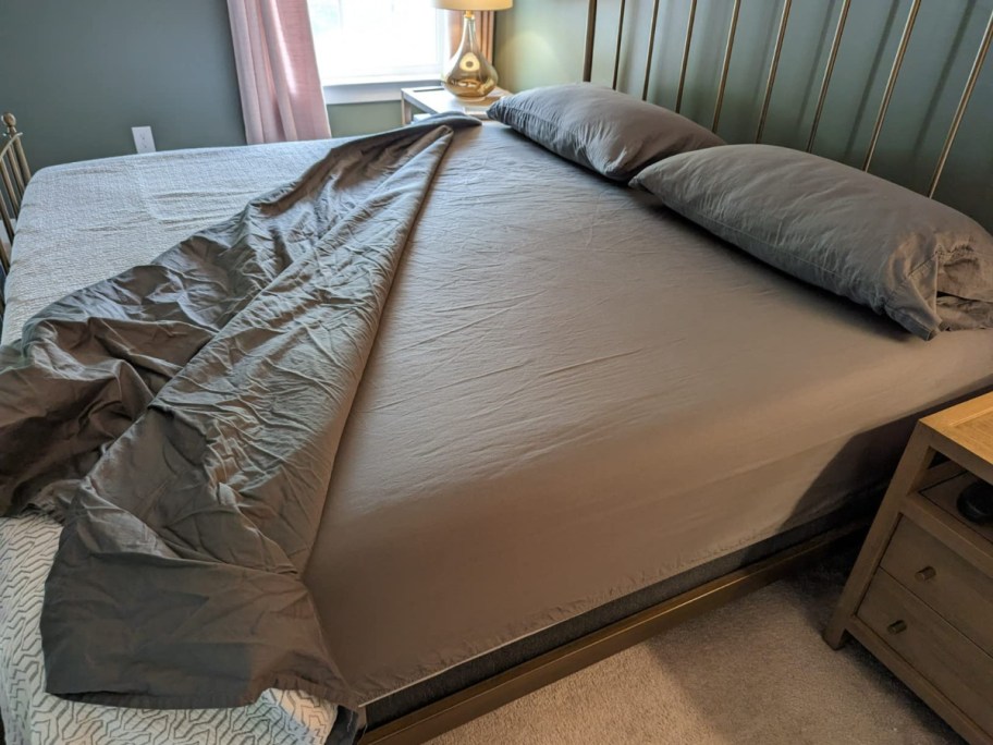 grey sheets on bed