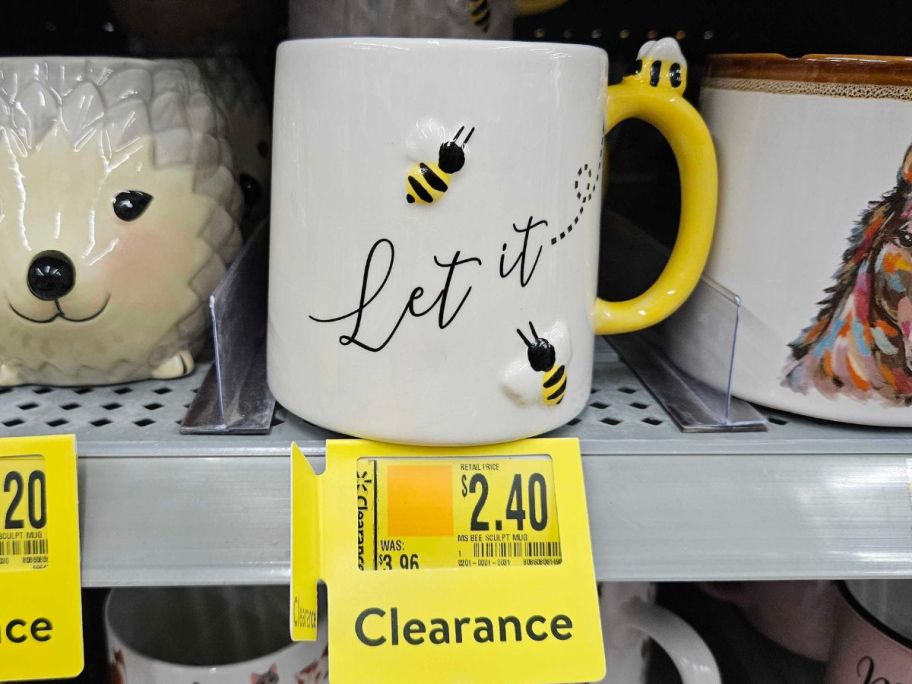 a white mug with bees on it and text 