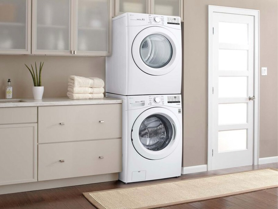 white stacked washer and dryer in laundry room 
