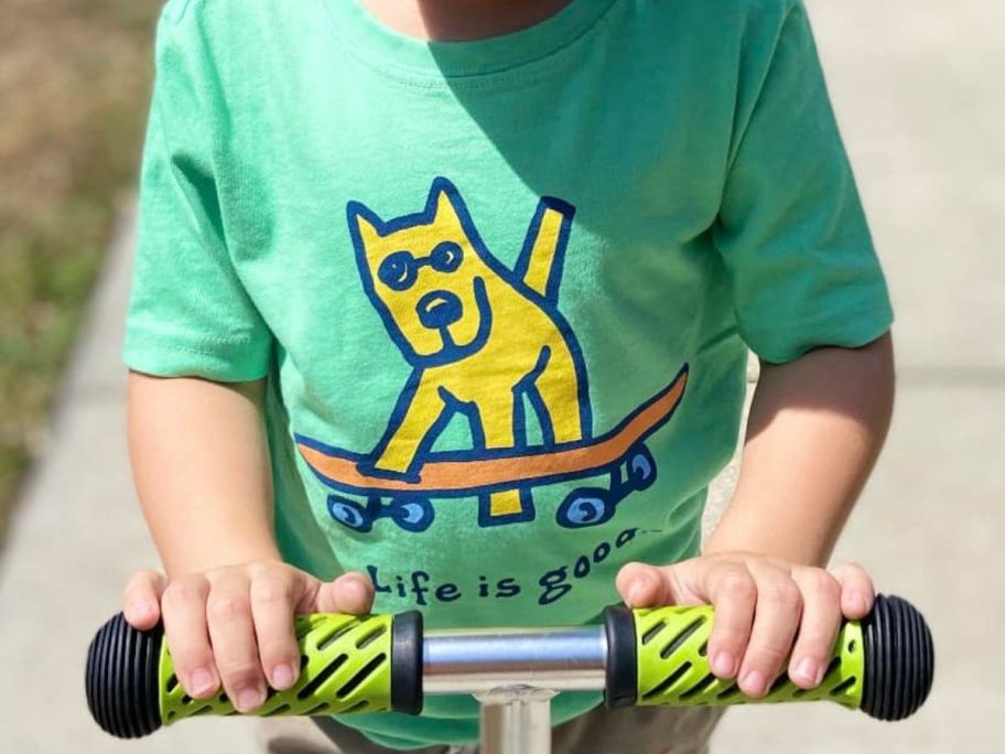 kid wearing Life is Good tee while on scooter