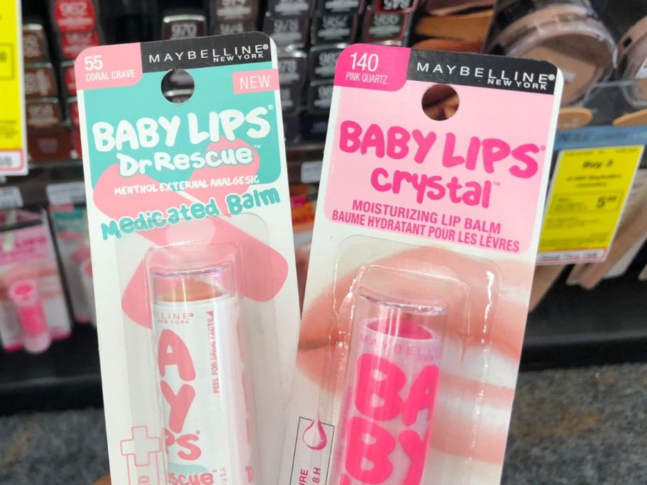 hand holding two Maybelline Baby Lips Moisturizing Lip Balms