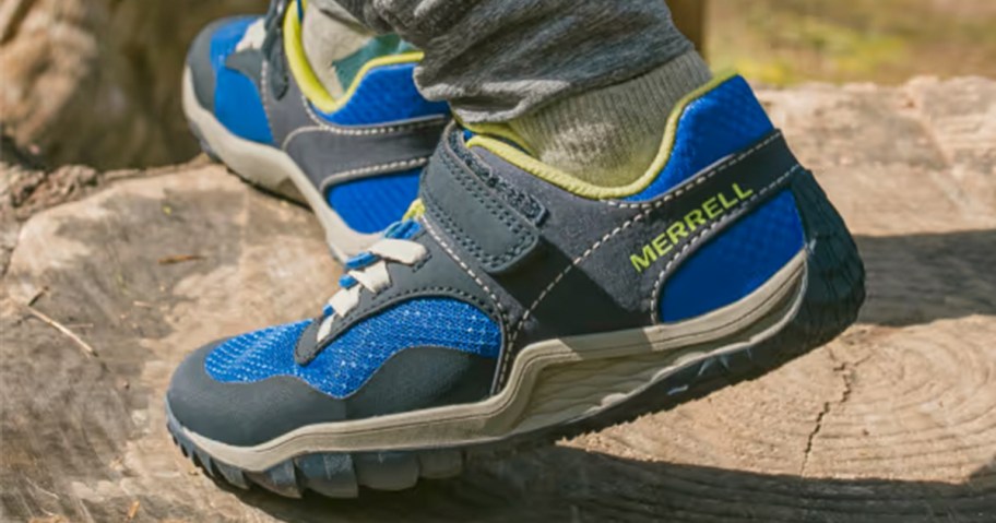 child wearing green and gray shoes