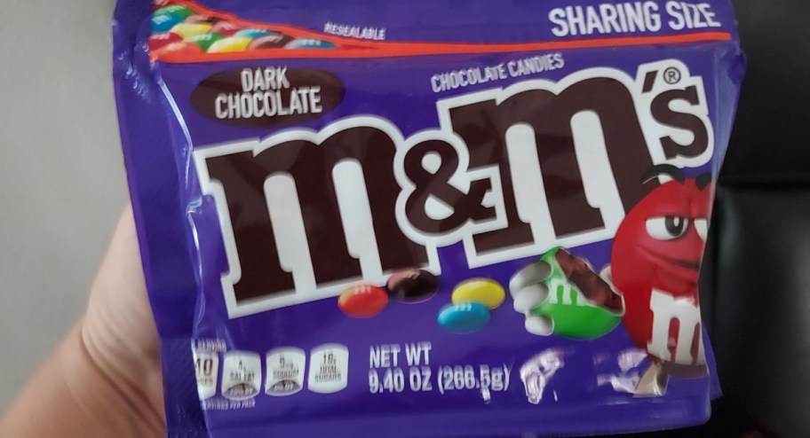 m&m sharing bag in persons hand