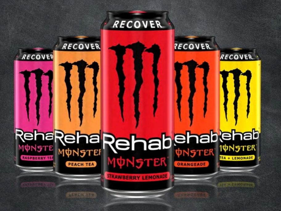 5 cans of monster energy on black background