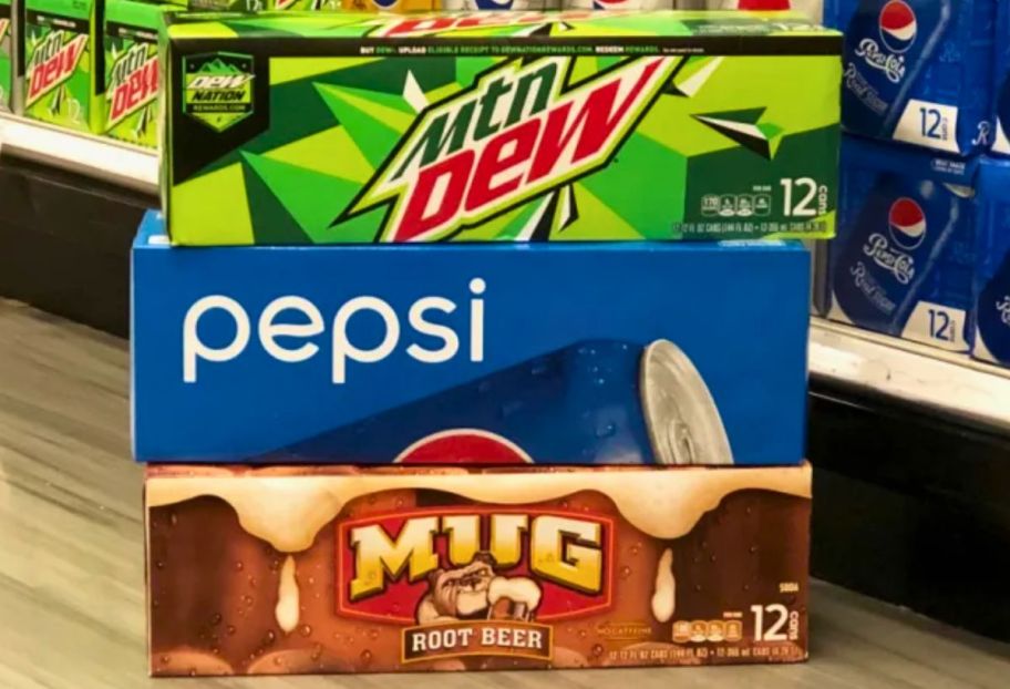 12 pack of mountain dew, pepsi and mug 12 oz sodas stacked on a store aisle