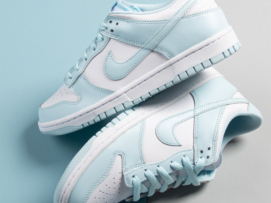 a pair of white and light blue nike dunk shoes 