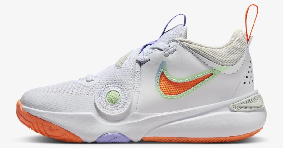 kid's Nike basketball shoe in white with orange and blue accents