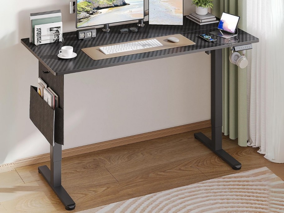 black standing adjustable height desk in an office 