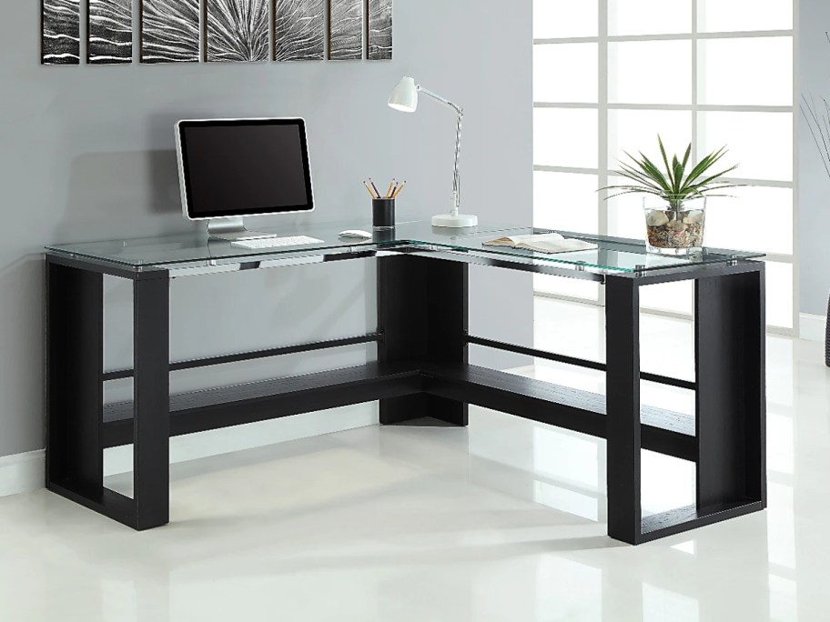 corner desk with dark wood base and legs and glass top 