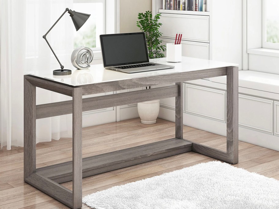 gray and white desk with laptop on top 