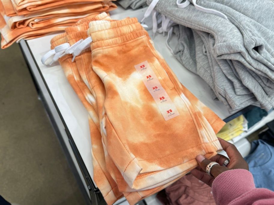 old navy girls shorts on table in store being held by hand