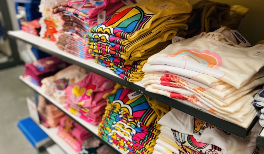 a table of folded kids graphic tees in an old navy store