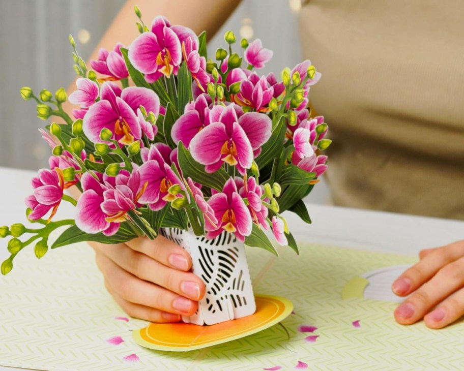 hand holding pink orchid 3d paper bouquet