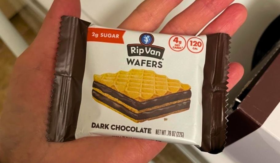 womans hand holding a package of rip van dark chocolate keto wafers