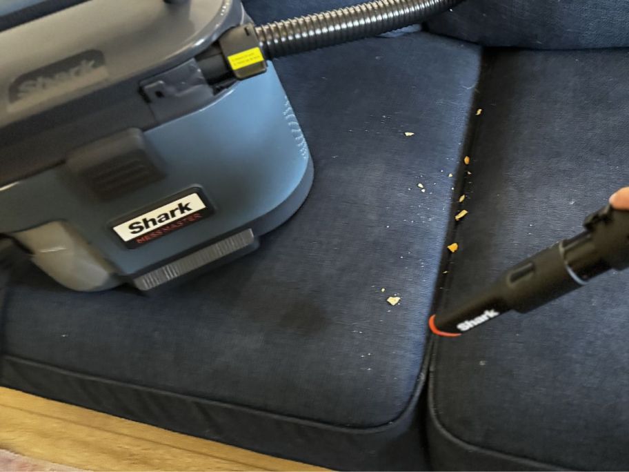 Shark MessMaster Portable Wet & Dry Vacuum w/ Car Detail Kit being used to clean up crumbs on couch