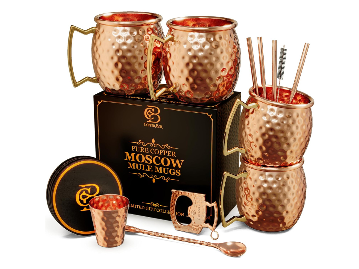 Set of copper Moscow Mule mugs and cocktail accessories