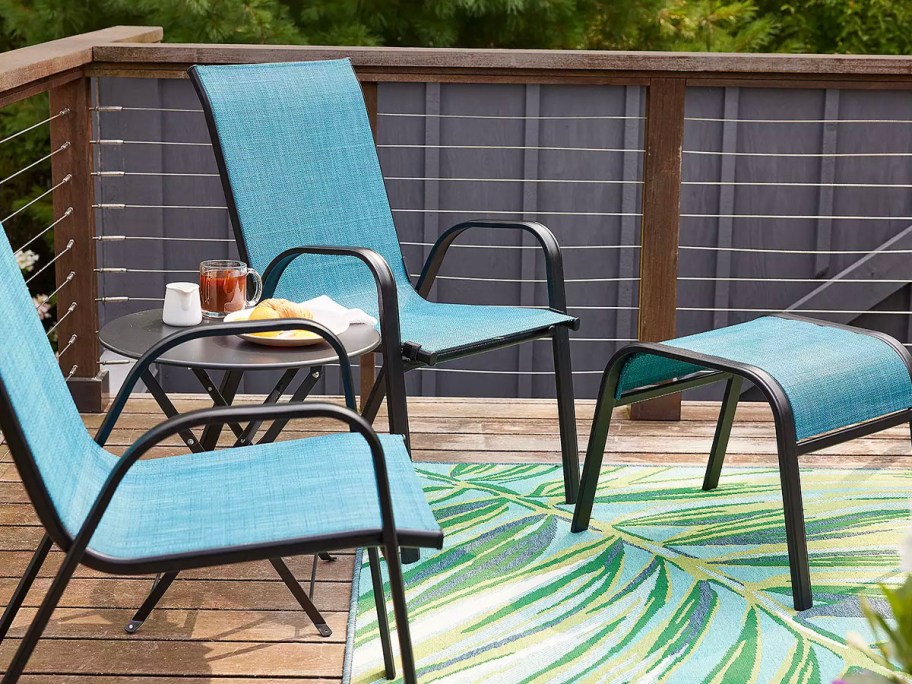 two teal chairs and matching table on patio 