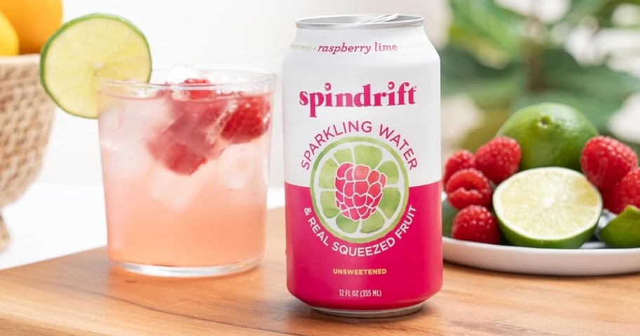 spindrift raspberry lime sparking water can next to glass on table